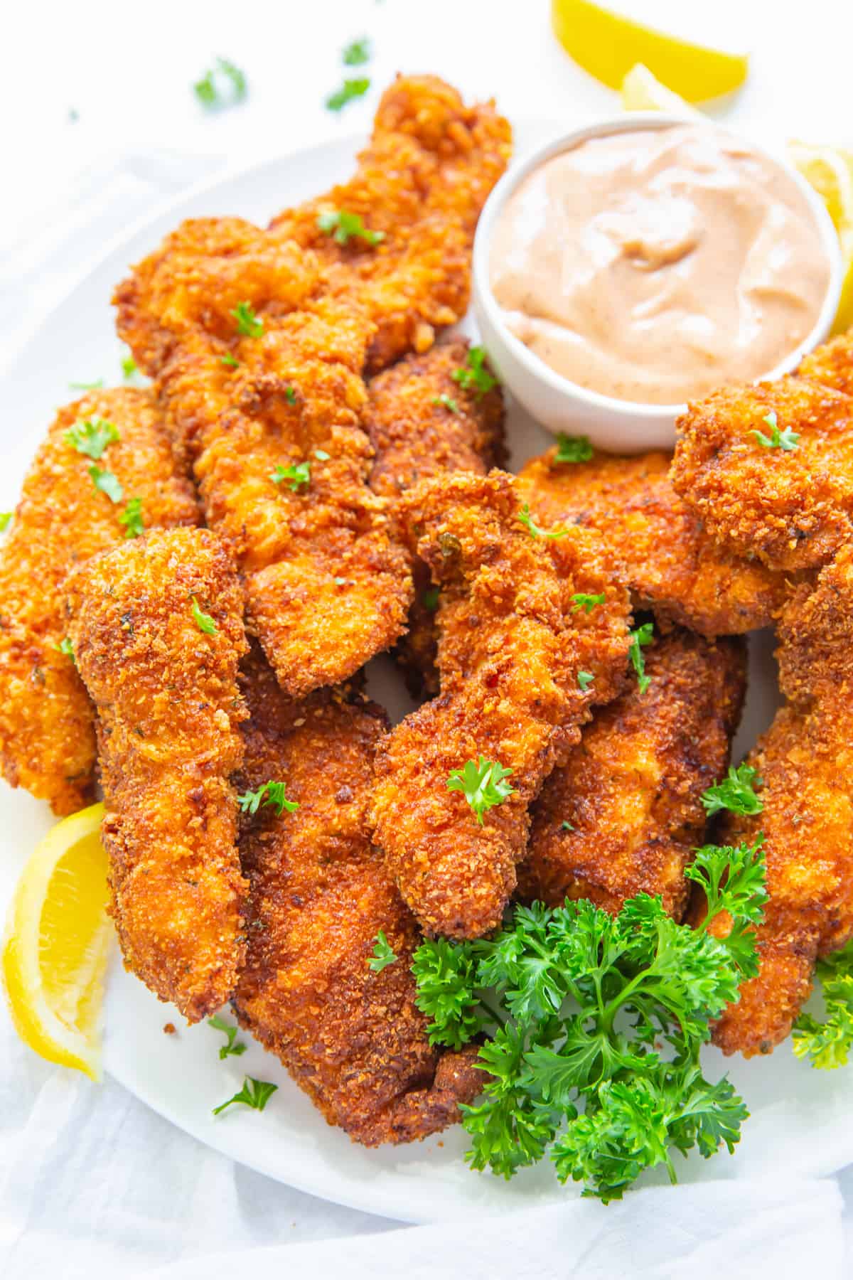 close up of copycat raising canes chicken fingers and sauce.