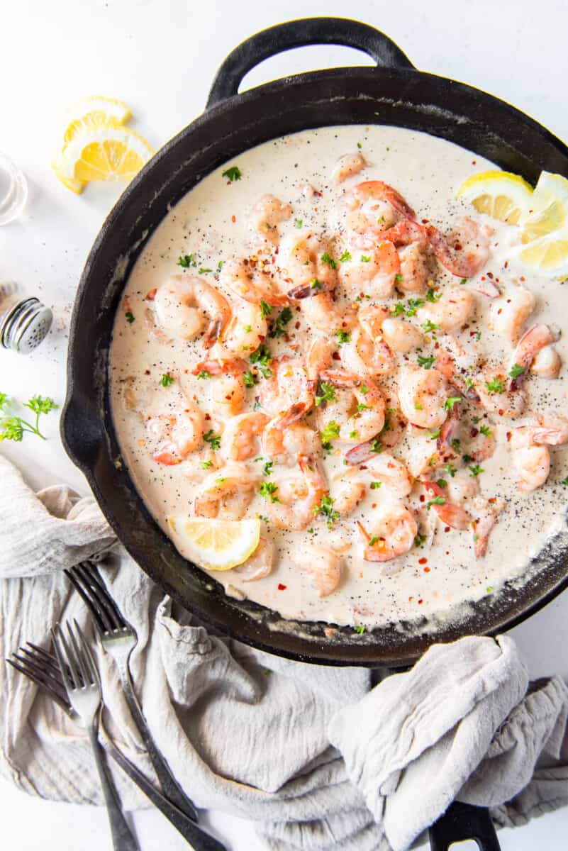 overhead view of creamy parmesan shrimp in a skillet.