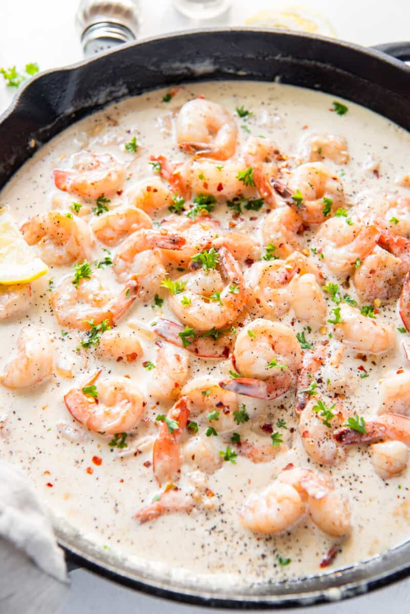 close up of creamy parmesan shrimp in a skillet.