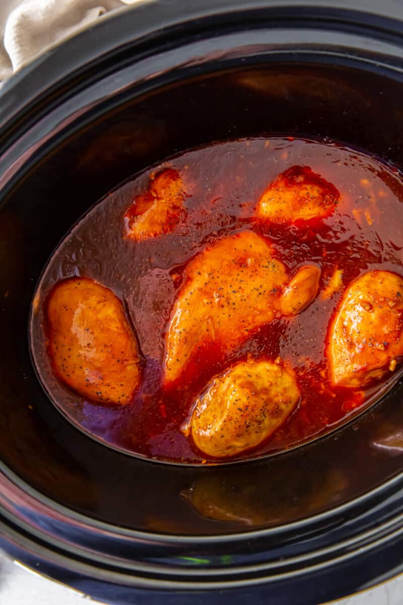 overhead view of crockpot bbq chicken breasts in a crockpot.