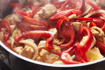 chicken and peppers in a skillet.