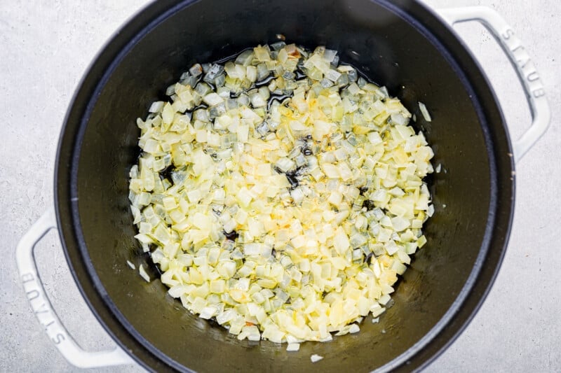 onions and garlic in a white dutch oven.