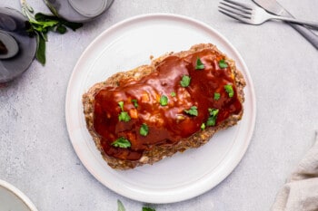 glazed instant pot meatloaf on a white serving plate.