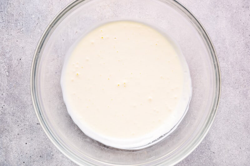 heavy cream and powdered sugar in a glass bowl.