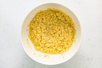 overhead view of cooked orzo in a white bowl.