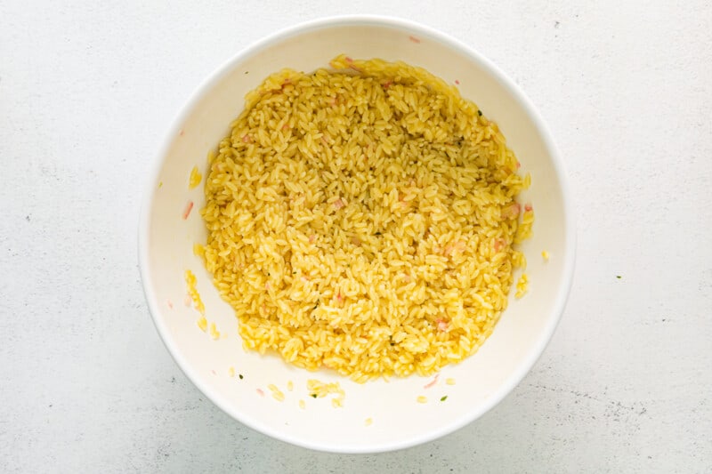 overhead view of cooked orzo in a white bowl.