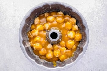 caramel coated biscuit balls layered in a bundt pan.