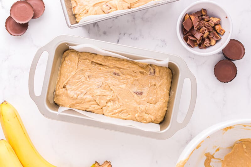 reeses peanut butter cup banana bread batter in a loaf pan.