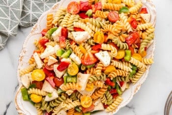 tricolor pasta salad in a white serving bowl.