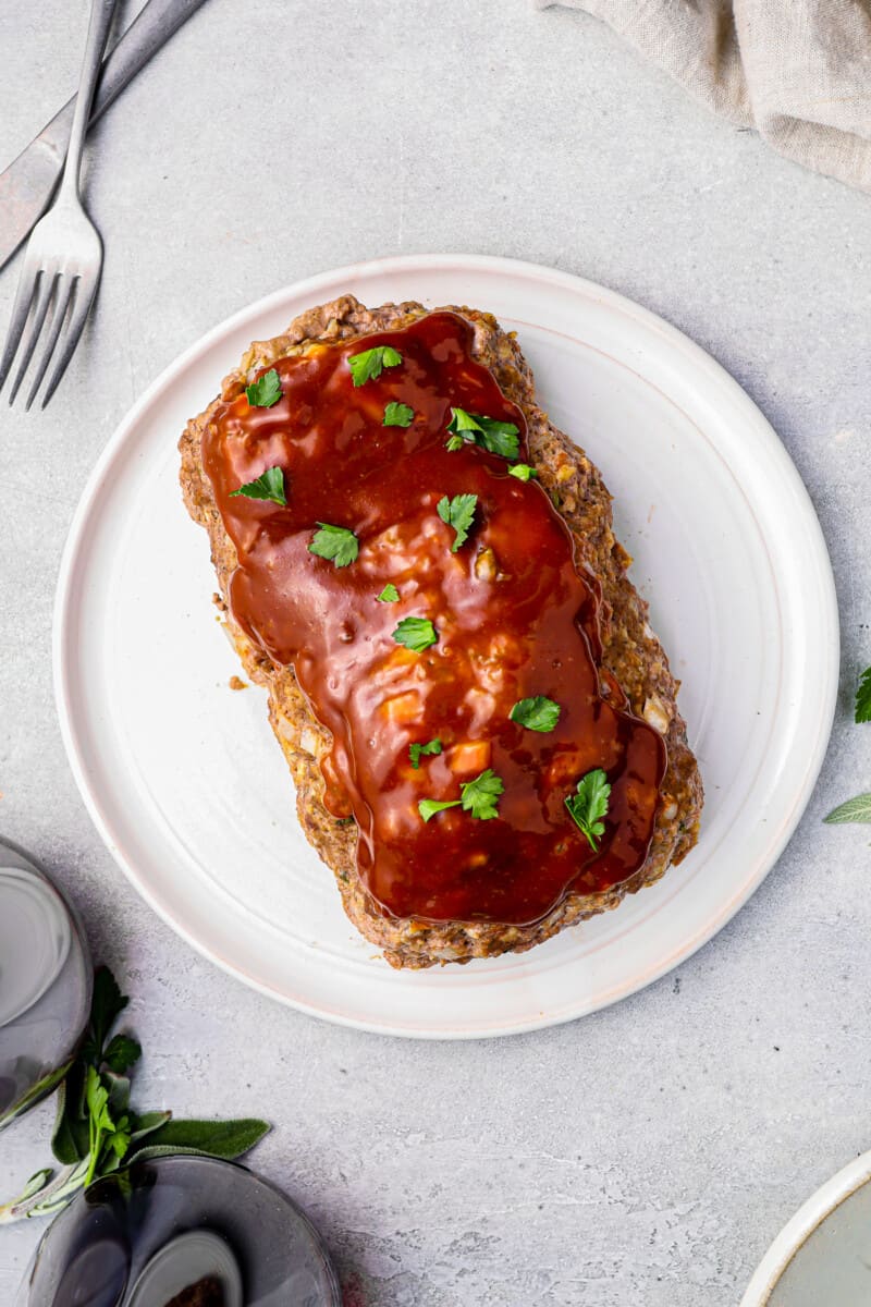 glazed instant pot meatloaf on a white serving plate.