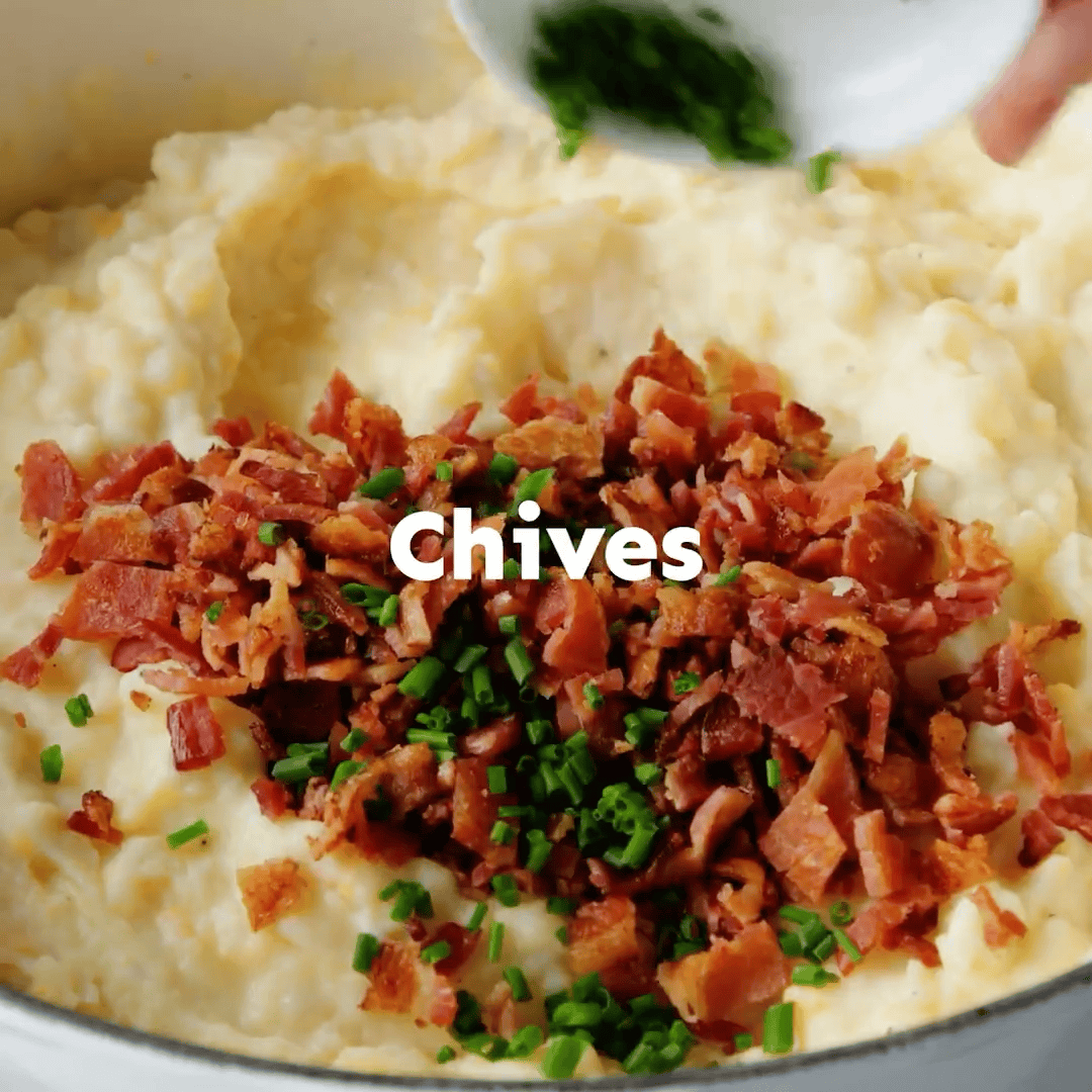 Combining the mashed potatoes with the chives and bacon.