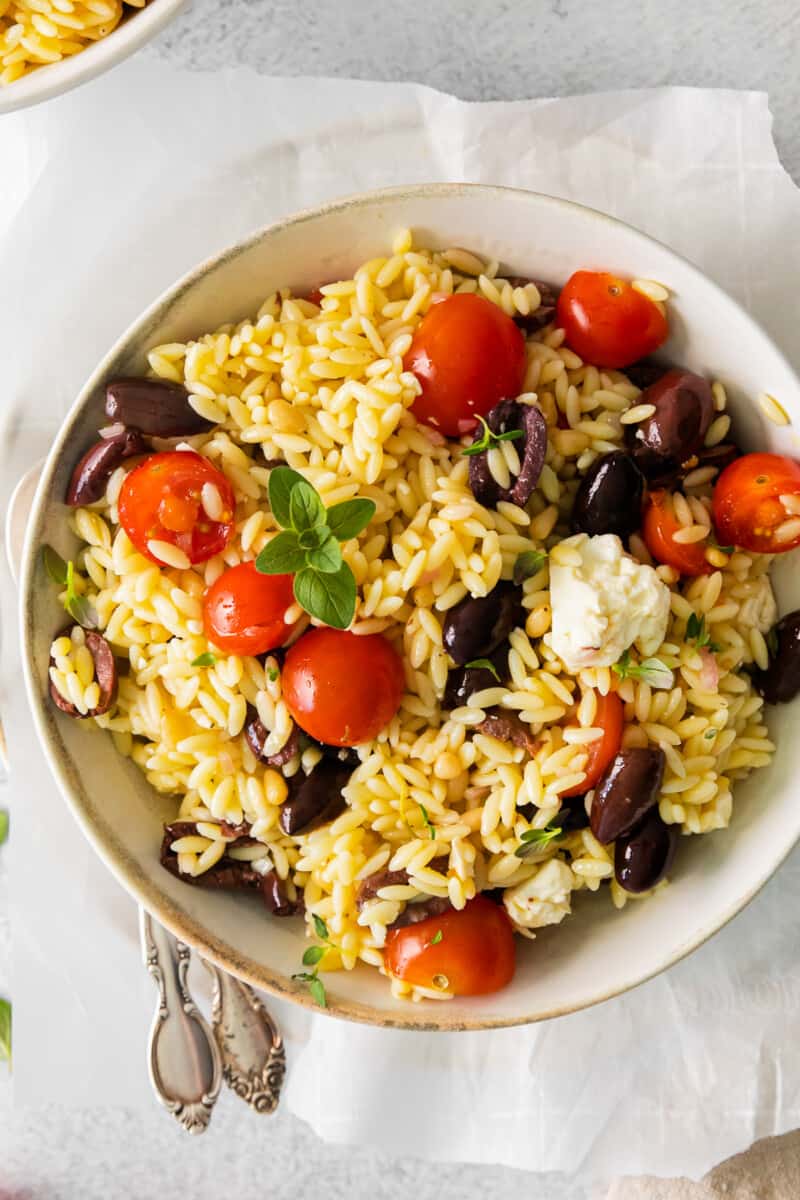 mediterranean orzo salad in a white bowl.