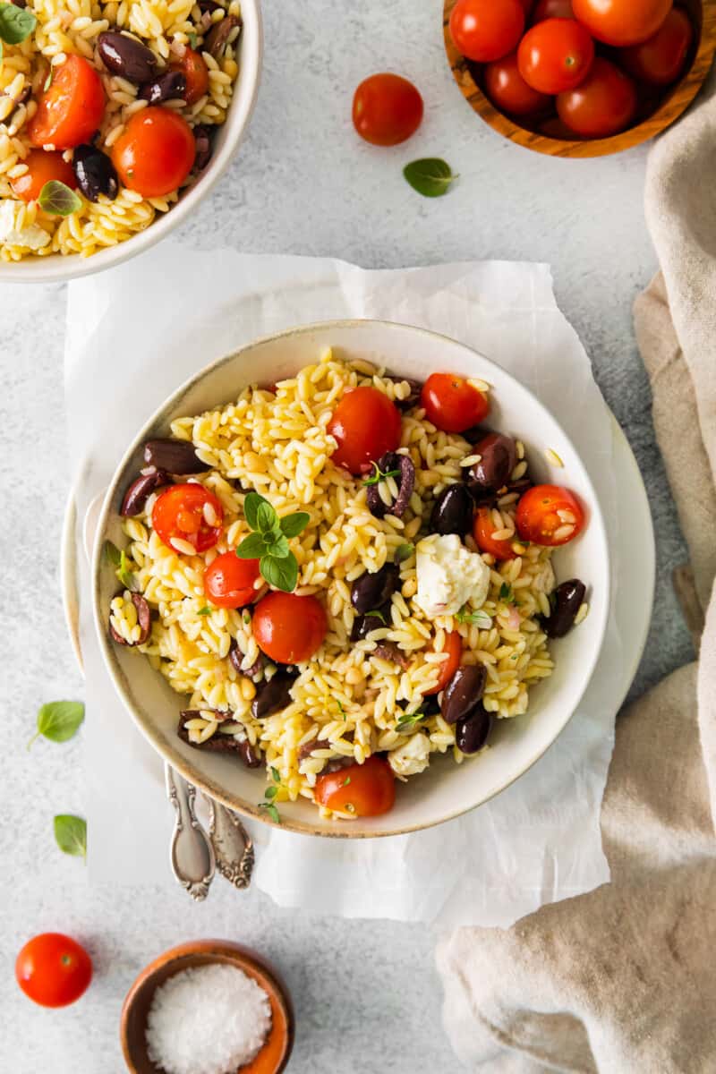 mediterranean orzo salad in a white bowl.