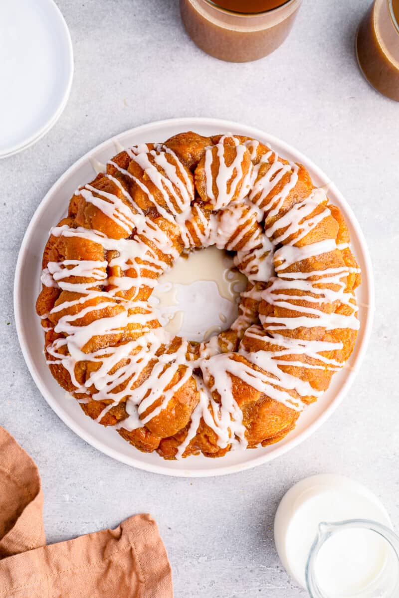 overhead view of iced easy monkey bread on a white serving plate.