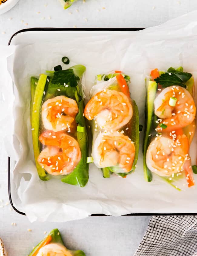 close up of shrimp summer rolls in a rectangular tray.