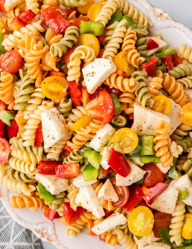 tricolor pasta salad in a white serving bowl.