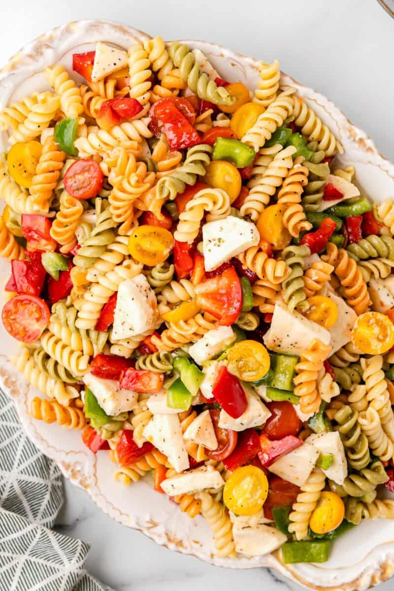 tricolor pasta salad in a white bowl.