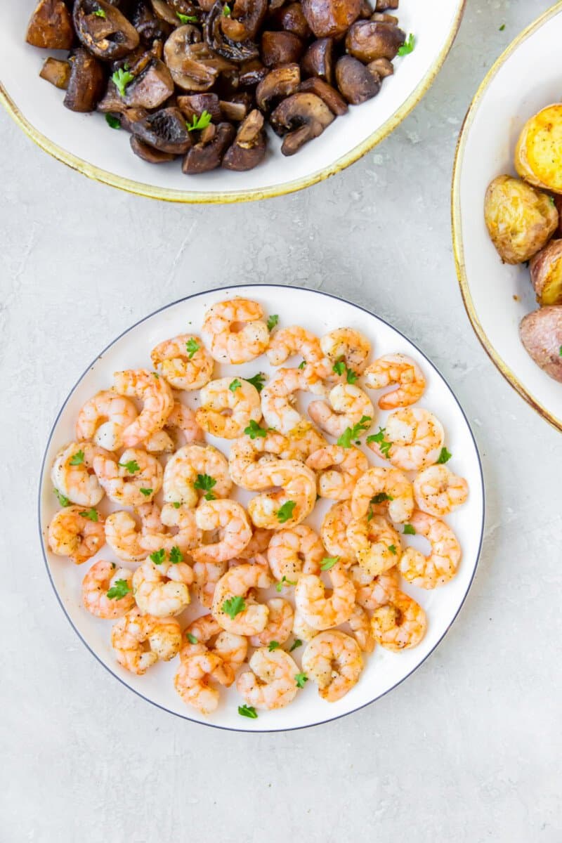 air fryer garlic shrimp on a white plate.