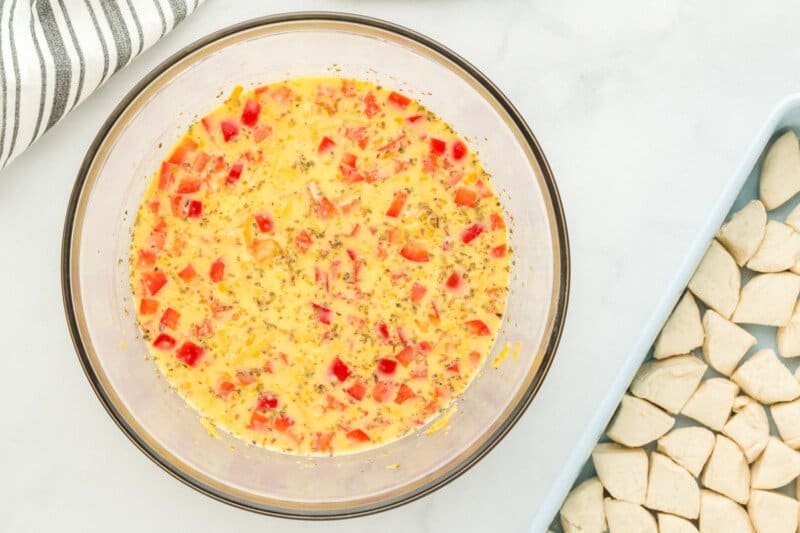 milk cheese egg biscuit and bell pepper in a glass bowl.