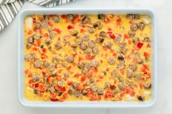 unbaked biscuit breakfast casserole in a baking pan.