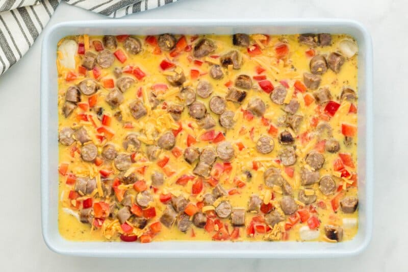 unbaked biscuit breakfast casserole in a baking pan.