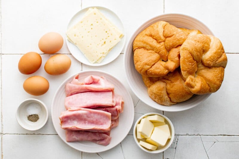 overhead view of ingredients for croissant breakfast sandwiches.
