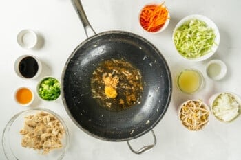 garlic and ginger sizzling in a frying pan.