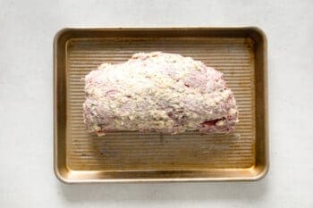 seasoned crockpot beef tenderloin on a sheet pan.