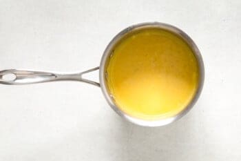 dijon and egg yolks added to bearnaise sauce in a saucepan.