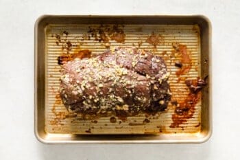 cooked crockpot beef tenderloin on a sheet pan.