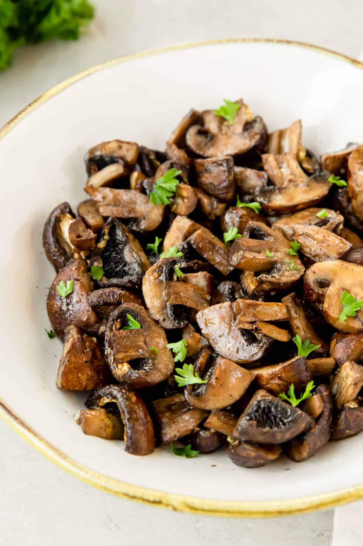 air fryer mushrooms in a white bowl.