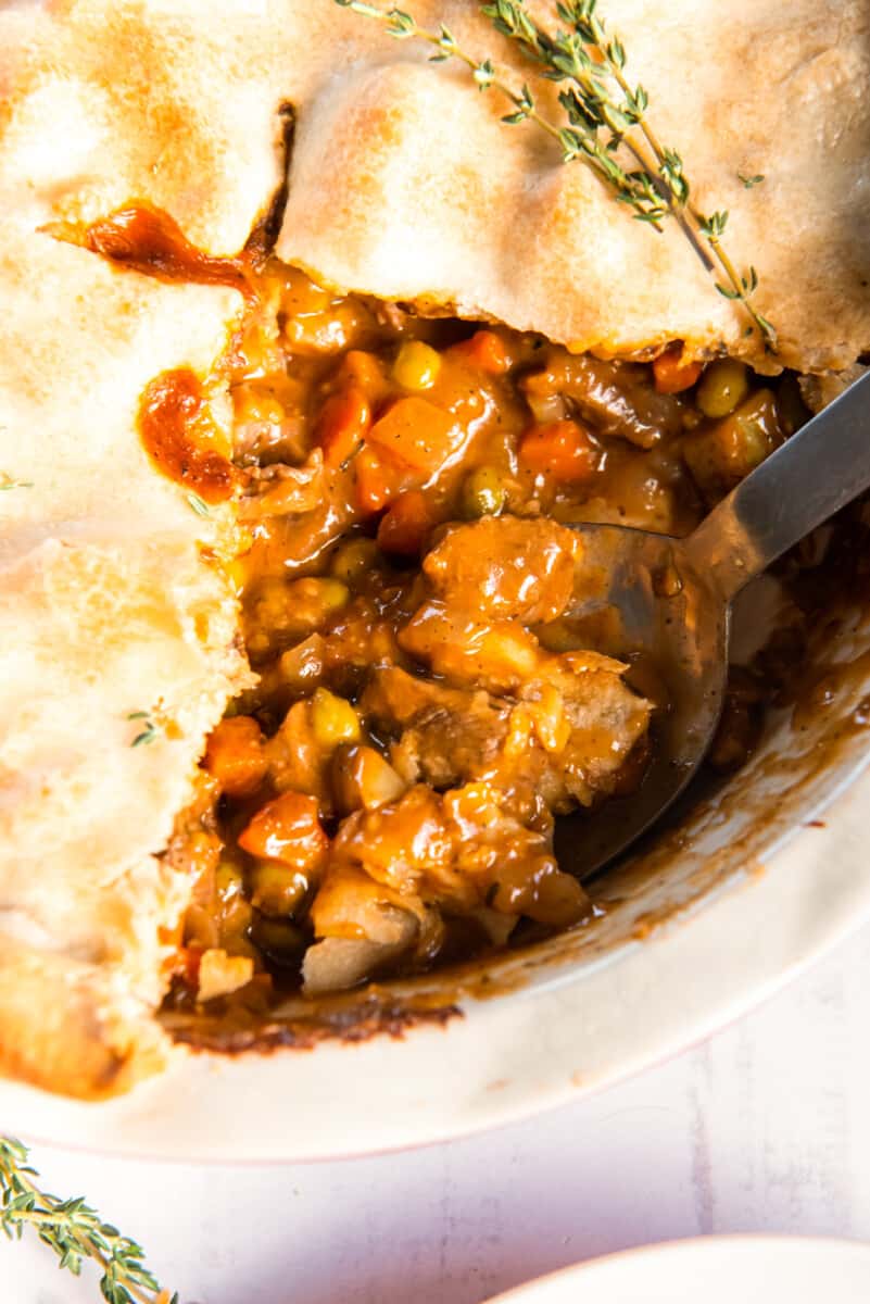 sliced beef pot pie in a pie pan.