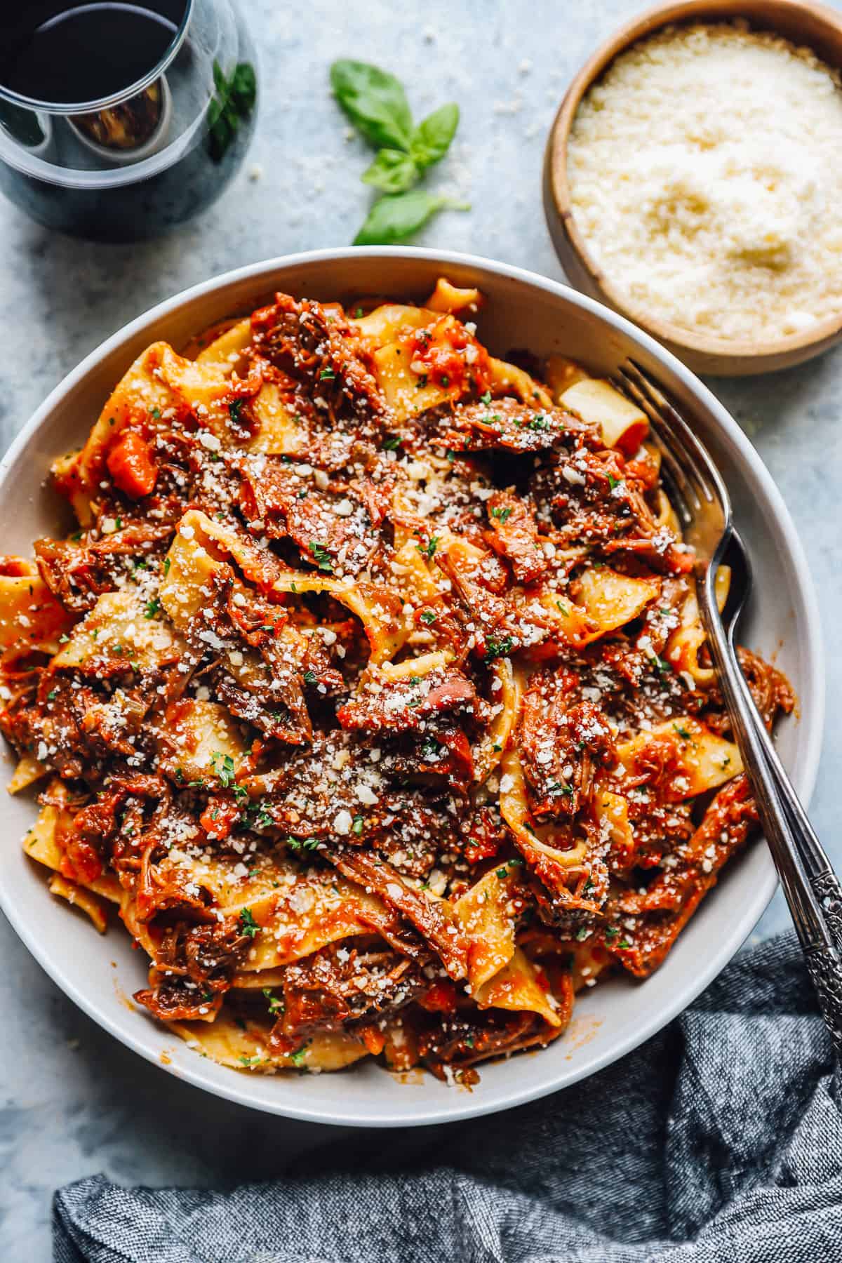 beef ragu in a white bowl with a fork.