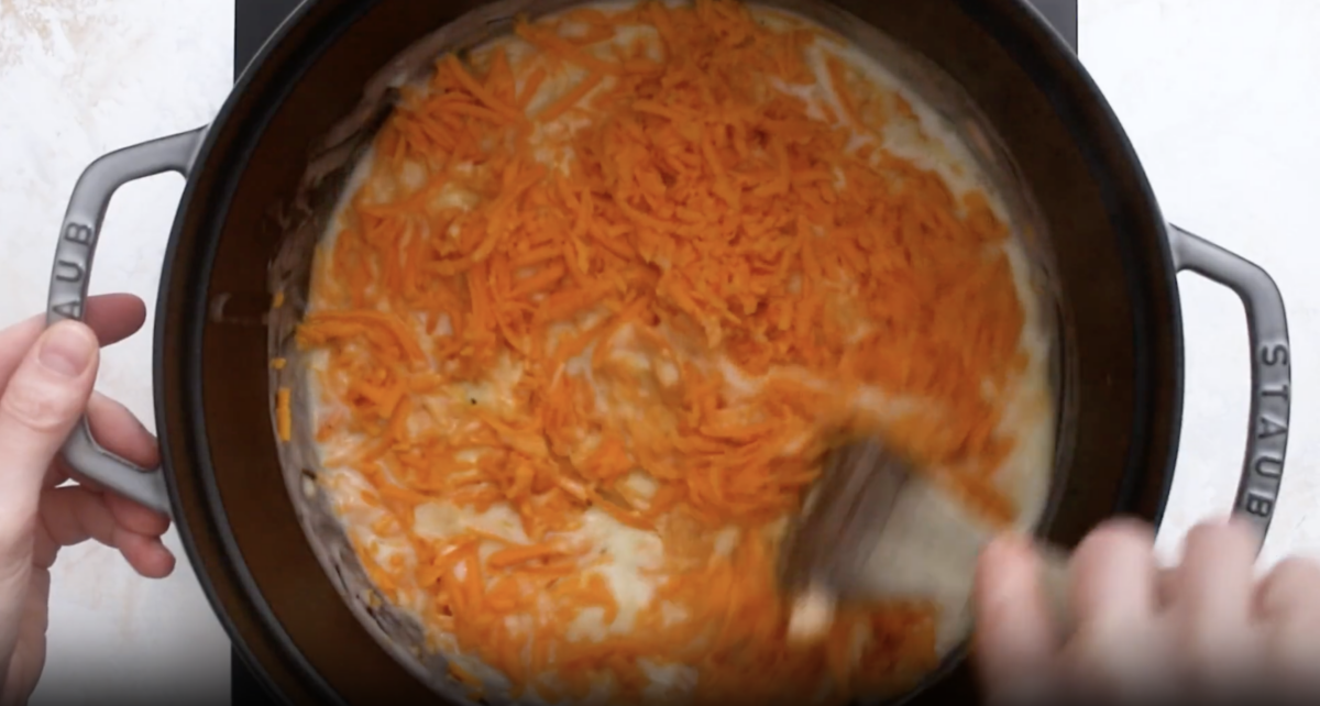 shredded cheese stirred into cream in a dutch oven.