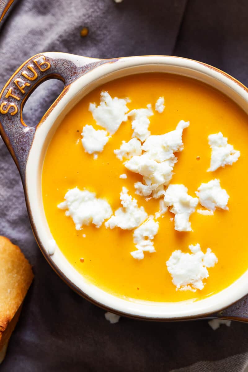 bowl of beer cheese soup with feta crumbles