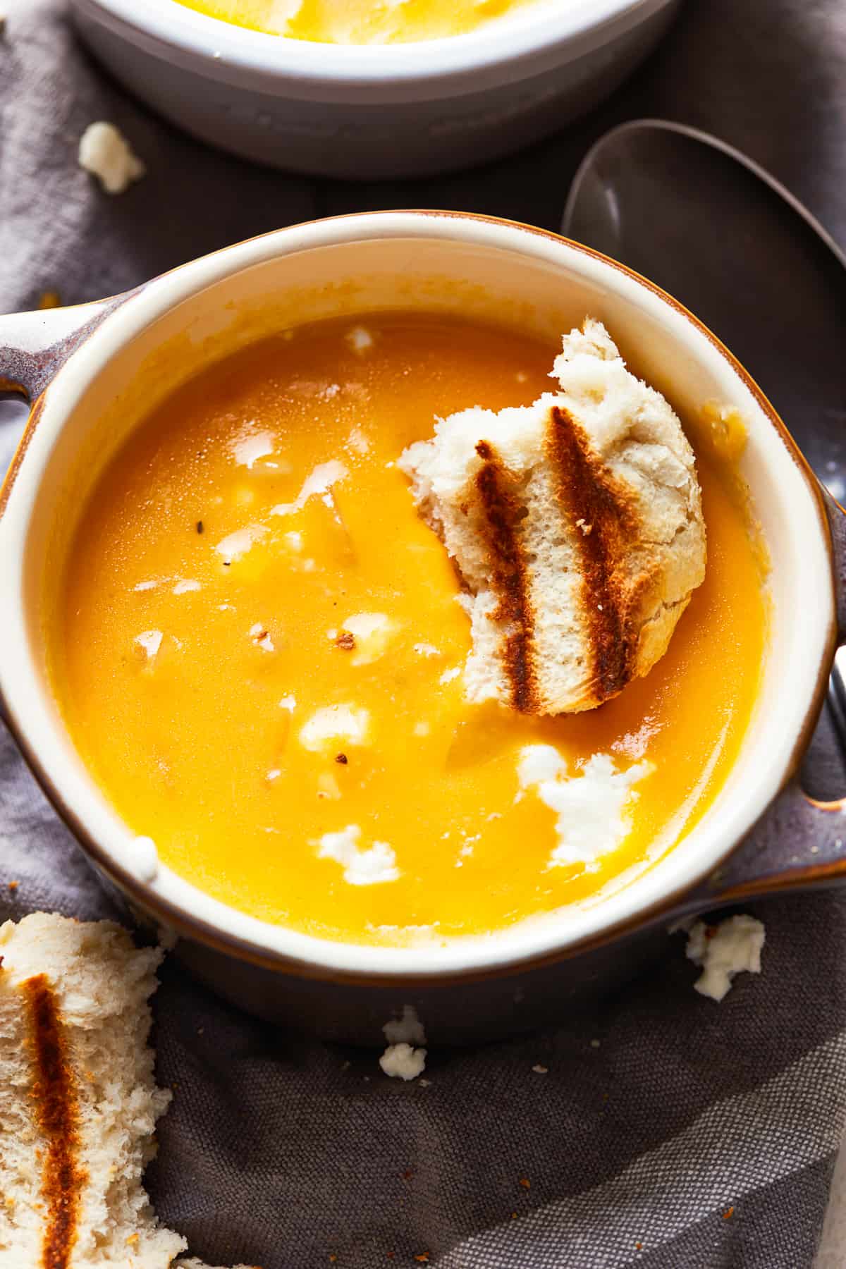 This Beer Cheese Soup recipe is so delicious and made in just 15 minutes! This creamy comfort food is the perfect winter dinner recipe. If you love cheese and beer (what could be better?), this easy beer cheese soup is just for you. a bowl of creamy beer cheese soup