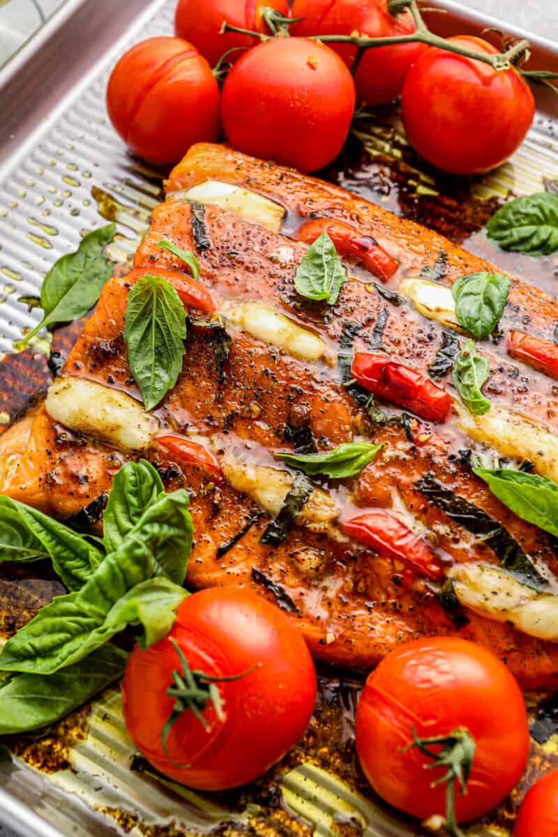 salmon stuffed with mozzarella and tomatoes on a baking tray