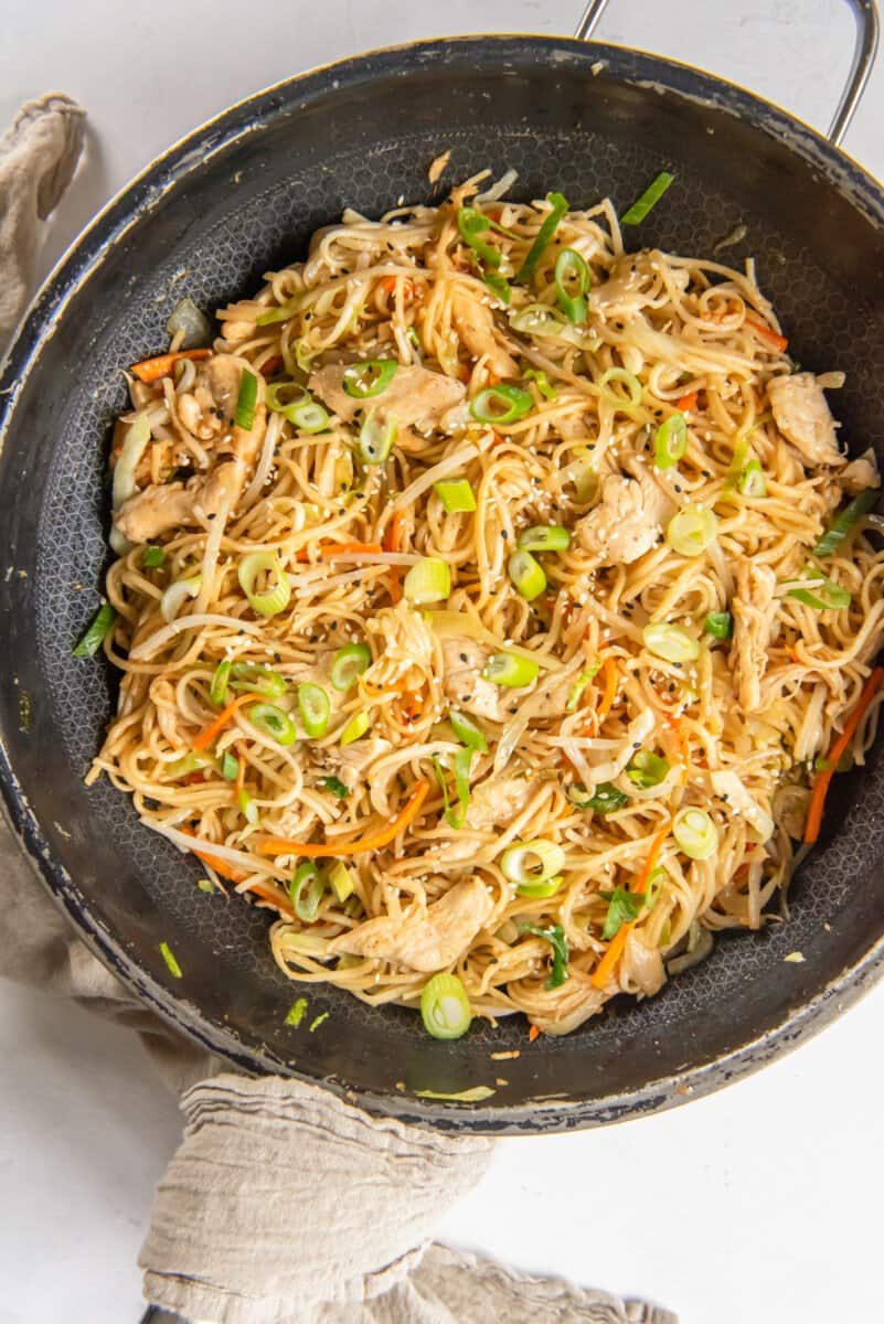 chicken lo mein in a frying pan.