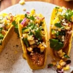 bbq chicken taco topped with beans and corn