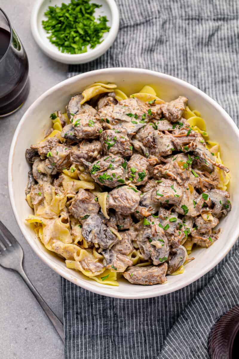 crockpot beef stroganoff in a white bowl.