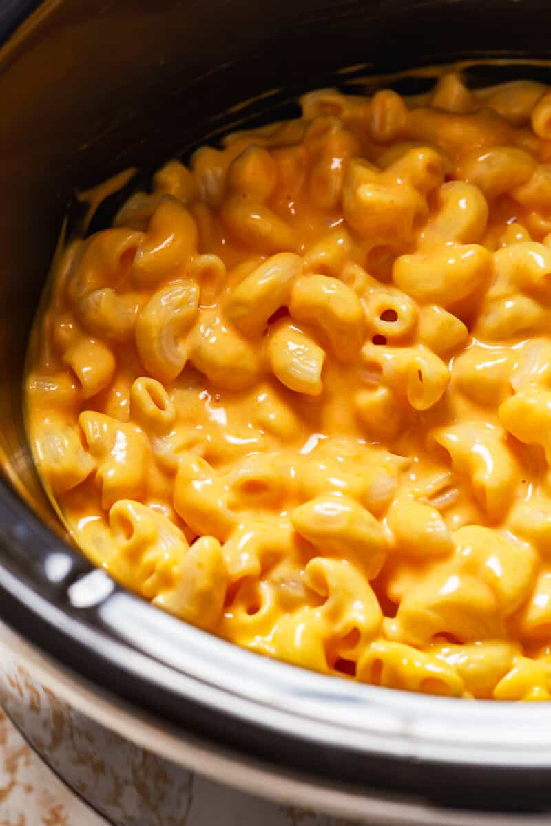 Crock Pot Mac and Cheese is a super simple recipe! This easy slow cooker macaroni and cheese makes the perfect side dish or weeknight dinner. It's virtually fool proof and comes out extra creamy and extra cheesy every time. Mac n cheese is always one of the best cheesy comfort foods around! mac and cheese in a slow cooker
