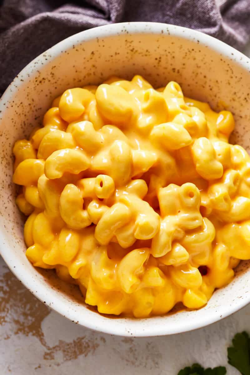 Slow Cooker Macaroni and Cheese - The Cookie Rookie close up on a bowl of creamy macarano and cheese