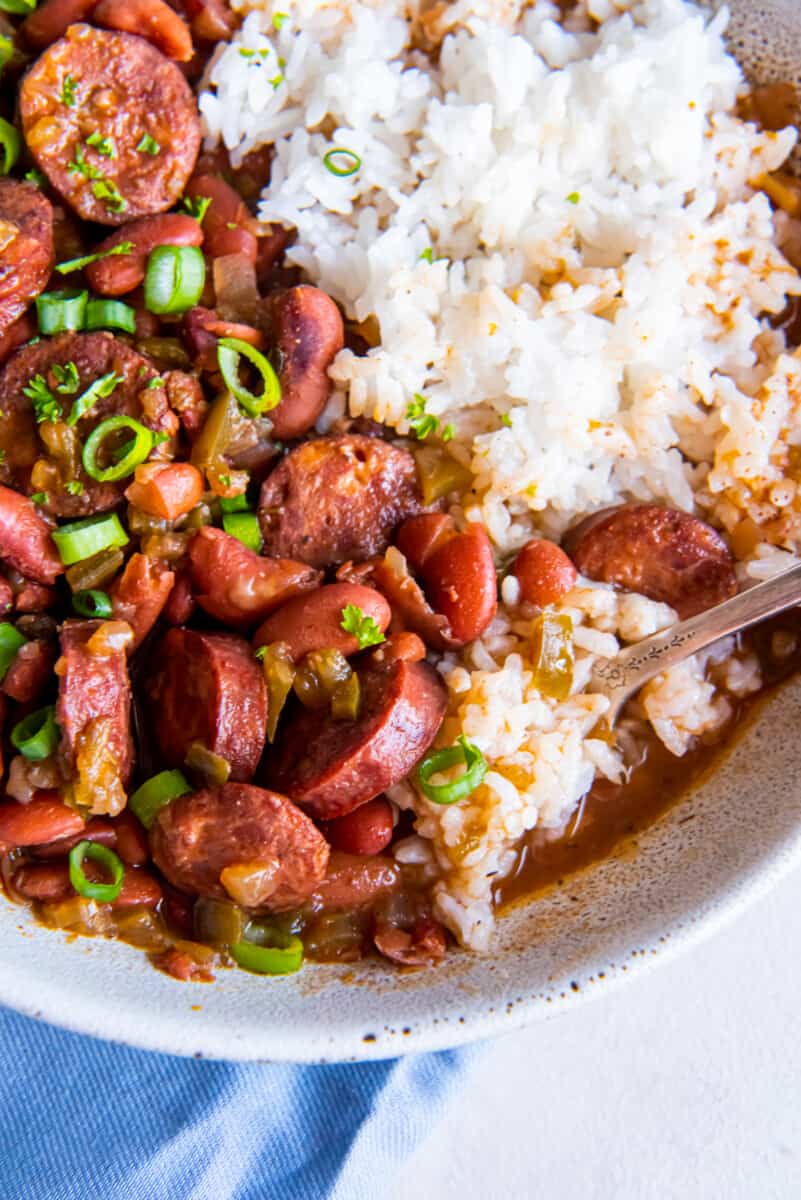 close up of crockpot red beans and rice in a white bowl.