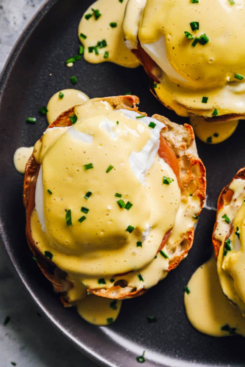 close up of eggs benedict on a back plate.