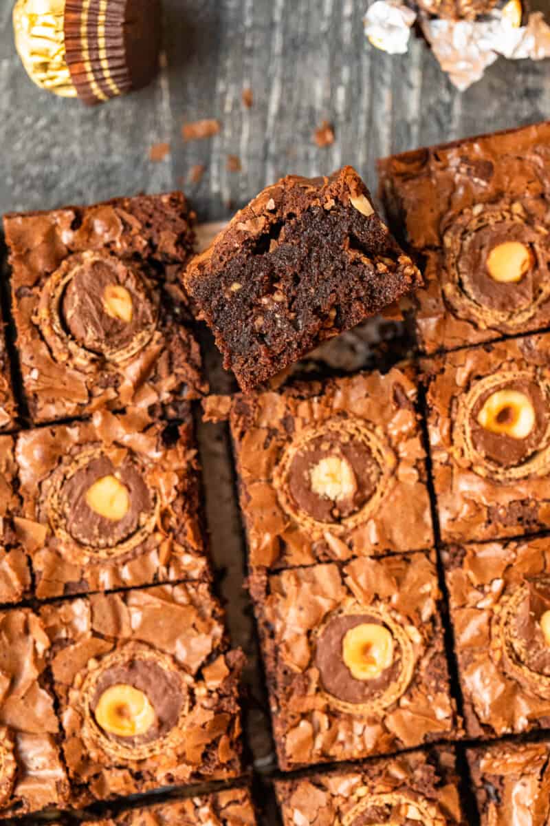 upturned ferrero rocher brownie leaning against cut ferrero rocher brownies.