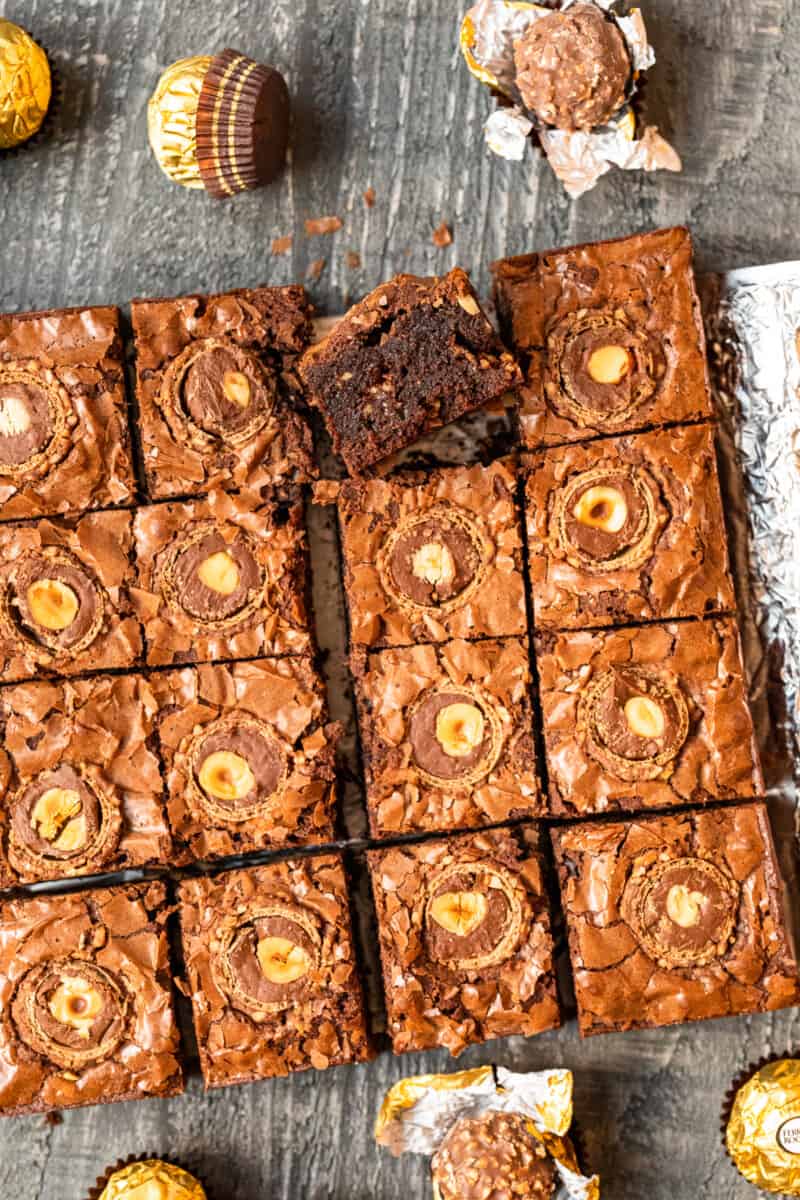 upturned ferrero rocher brownie leaning against cut ferrero rocher brownies.