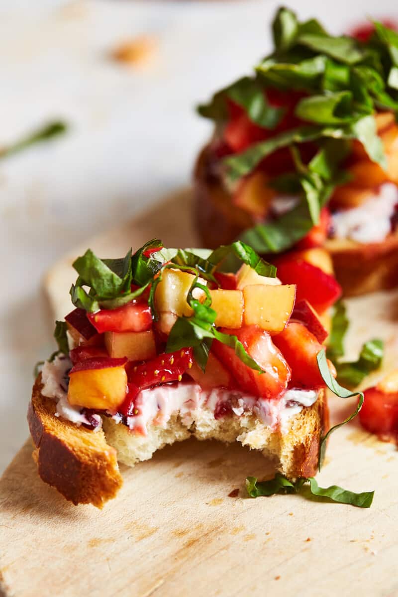 fruit and goat cheese bruschetta with a bite taken out
