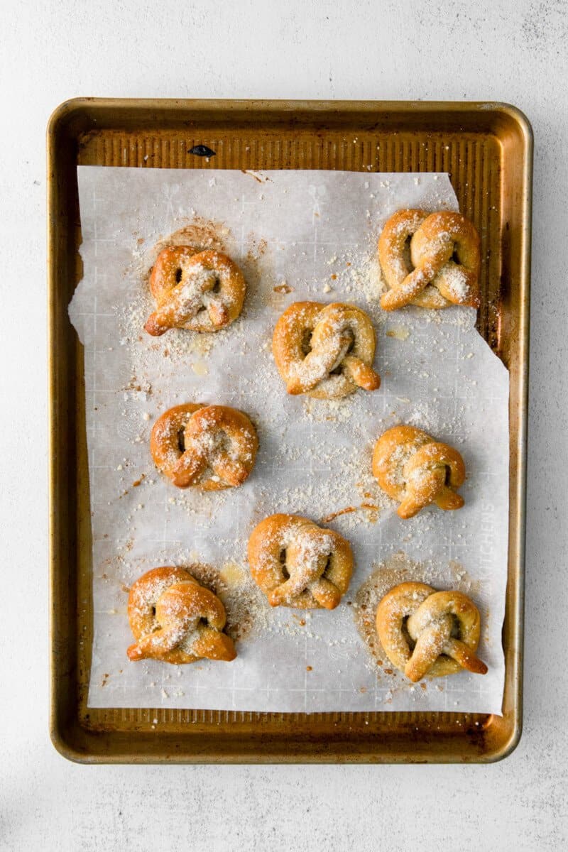 8 garlic parmesan soft pretzels on a baking sheet.