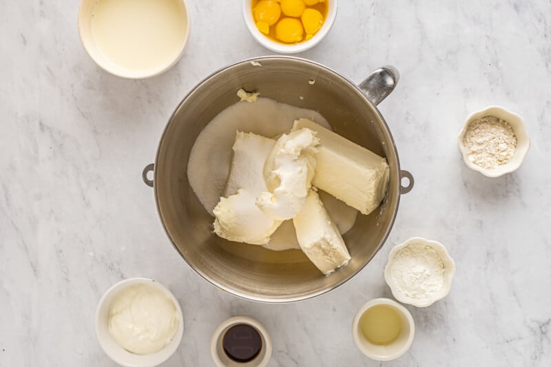 cream cheese sugar and mascarpone in a stainless mixing bowl.