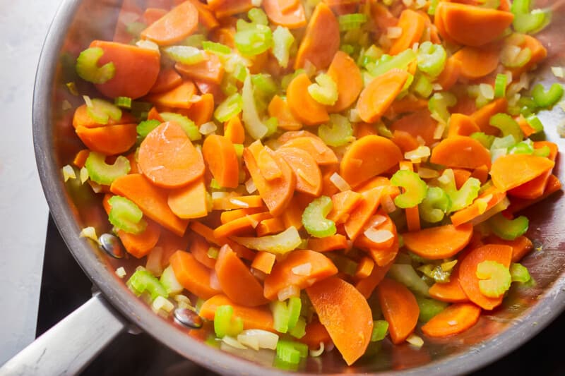 close up on a skillet filled with chopped vegetables